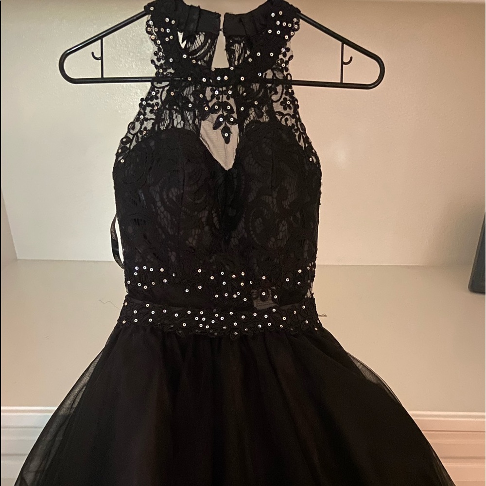 A fitted black dress thats poofy after the waist